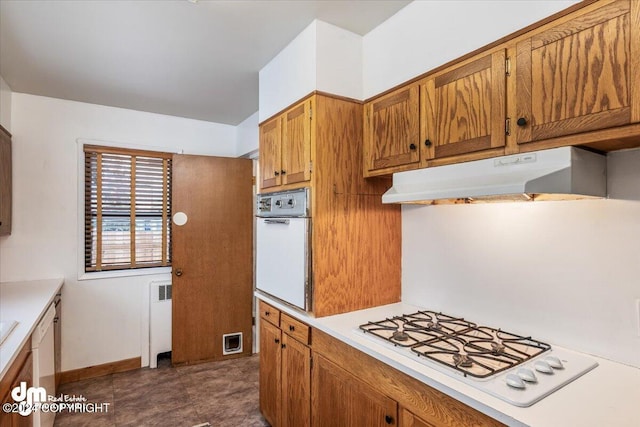 kitchen featuring white appliances and radiator heating unit