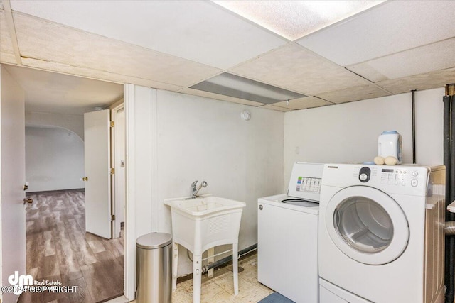 laundry area featuring washer and clothes dryer and light hardwood / wood-style floors