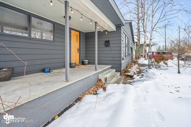 view of snow covered property entrance