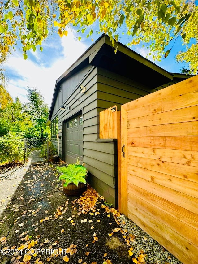 view of side of home featuring a garage