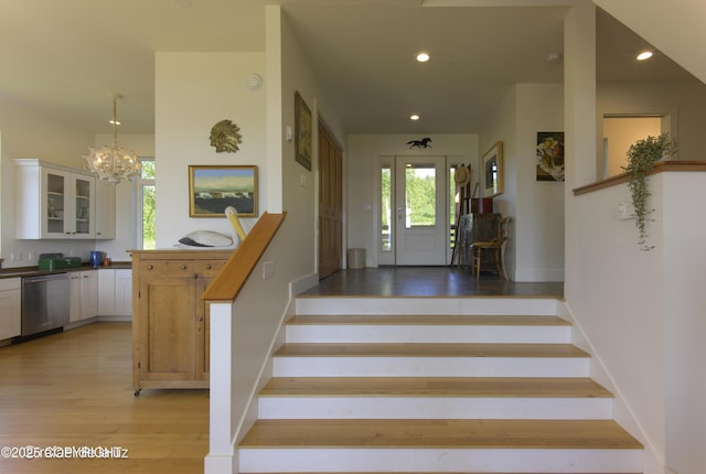 4760 Craftsman Rd, Homer, AK 99603 - stairway with wood finished floors, healthy amount of natural light, a chandelier, recessed lighting, and baseboards