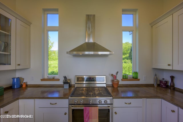 4760 Craftsman Rd, Homer, AK 99603 - kitchen featuring gas stove, wall chimney range hood, and plenty of natural light