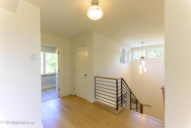 4760 Craftsman Rd, Homer, AK 99603 - corridor with an upstairs landing, plenty of natural light, wood finished floors, and baseboards