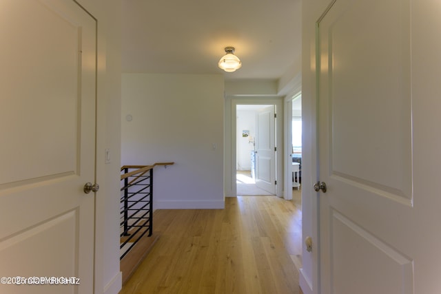 4760 Craftsman Rd, Homer, AK 99603 - hall featuring light wood-type flooring, baseboards, and an upstairs landing