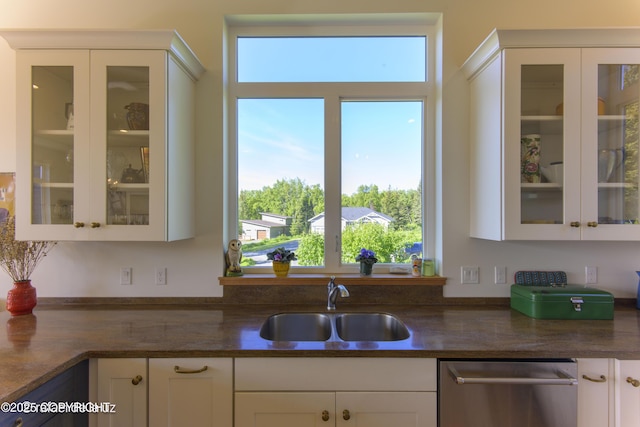4760 Craftsman Rd, Homer, AK 99603 - kitchen with dishwasher, a sink, white cabinetry, dark countertops, and glass insert cabinets