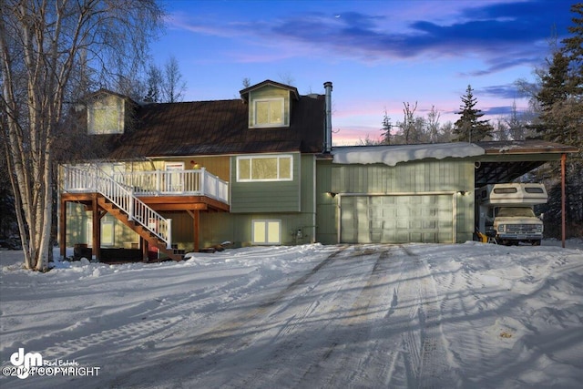 view of front of house with a wooden deck and a garage