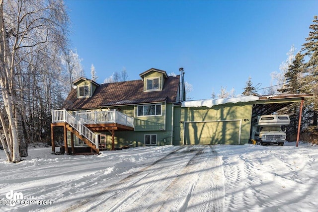 view of front facade with a garage and a wooden deck