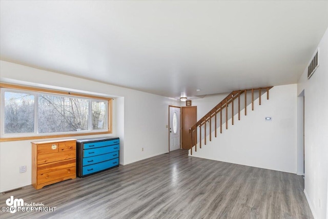 unfurnished living room with wood-type flooring