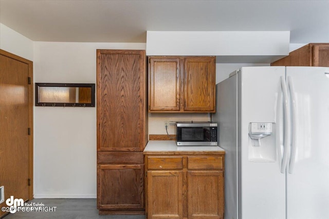 kitchen with white refrigerator with ice dispenser