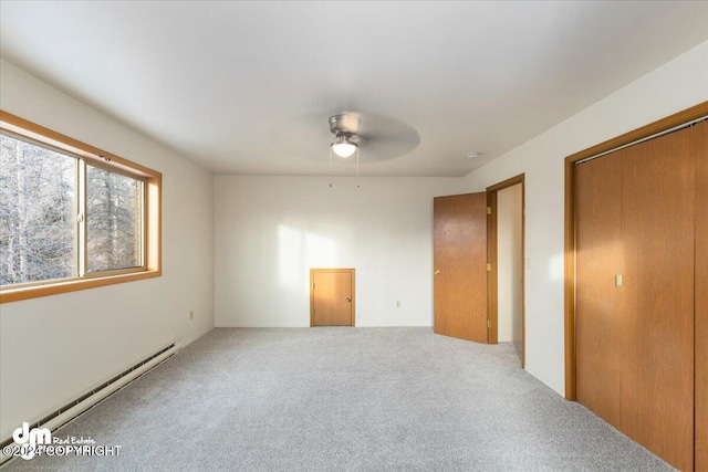 unfurnished bedroom featuring ceiling fan, carpet, and a baseboard radiator