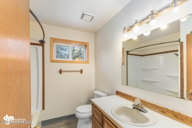 bathroom with vanity, toilet, and wood-type flooring