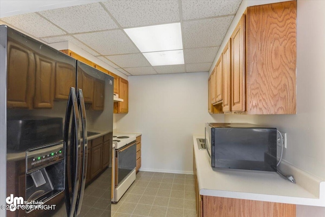 kitchen with electric range, a paneled ceiling, and black fridge with ice dispenser