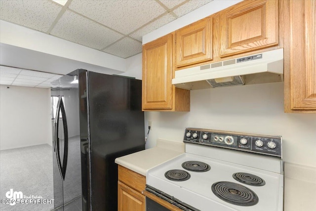 kitchen with black fridge, light colored carpet, white electric stove, and a drop ceiling