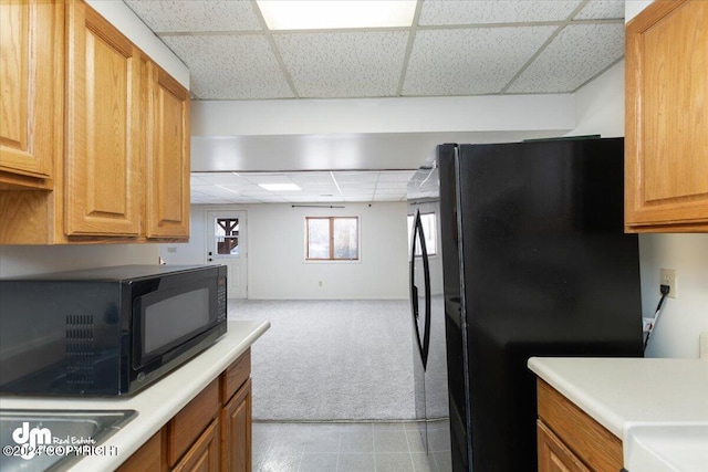 kitchen with a drop ceiling and black appliances