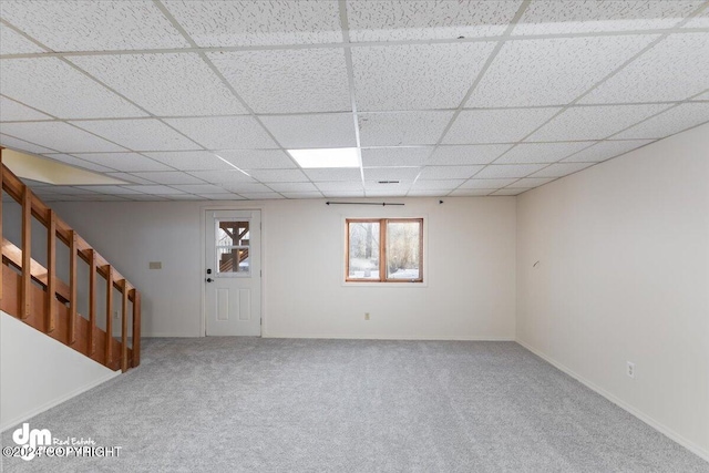 basement with carpet flooring and a paneled ceiling