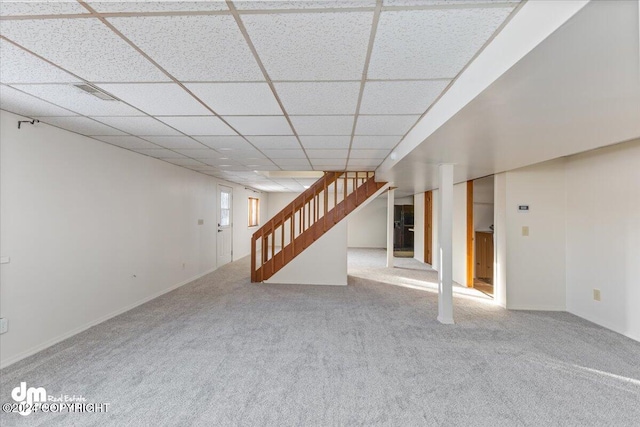 basement featuring carpet and a drop ceiling