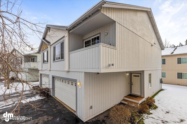 view of front facade featuring a garage and a balcony