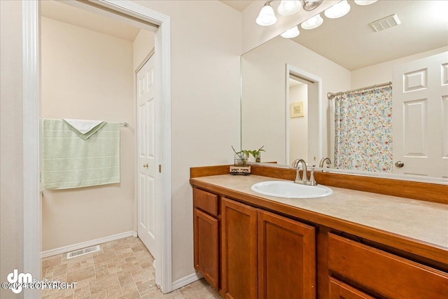 bathroom with vanity and a shower with shower curtain