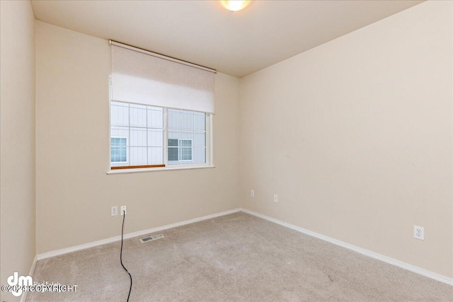 unfurnished room with light carpet