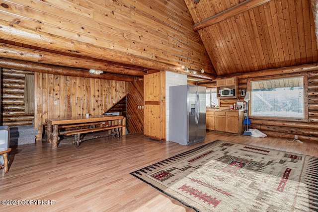 sitting room with beamed ceiling, high vaulted ceiling, and light hardwood / wood-style flooring