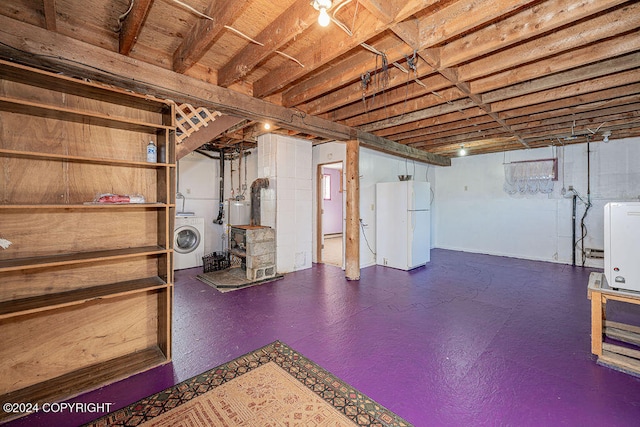 basement with white fridge and washer / dryer