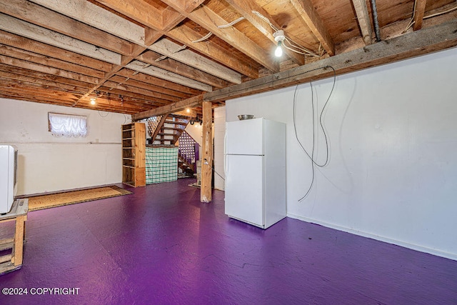 basement with white fridge