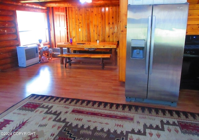 kitchen with hardwood / wood-style flooring and stainless steel refrigerator with ice dispenser