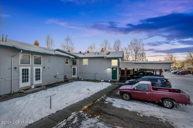 view of front of home with french doors and a carport