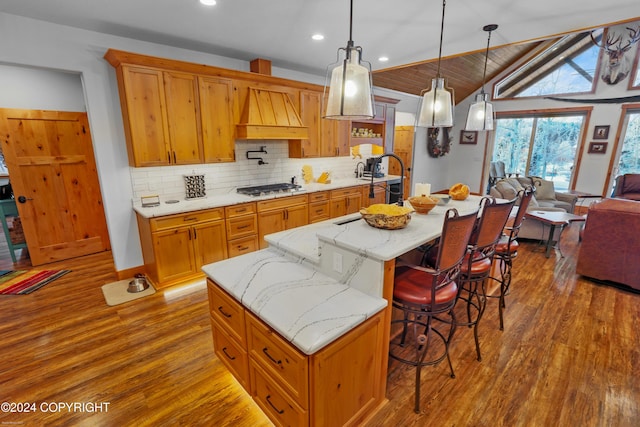 34184 House Dr, Soldotna, AK 99669 - kitchen with premium range hood, dark wood-style flooring, backsplash, a breakfast bar, and recessed lighting