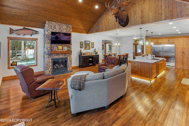 34184 House Dr, Soldotna, AK 99669 - living area with a chandelier, wood finished floors, a stone fireplace, high vaulted ceiling, and wood ceiling