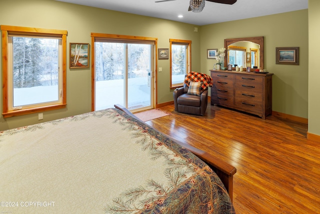 34184 House Dr, Soldotna, AK 99669 - bedroom with access to exterior, wood finished floors, multiple windows, recessed lighting, and baseboards