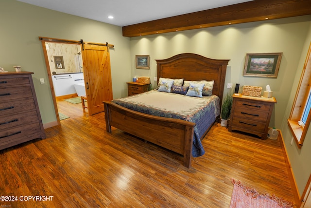 34184 House Dr, Soldotna, AK 99669 - bedroom with a barn door, recessed lighting, wood finished floors, beamed ceiling, and baseboards