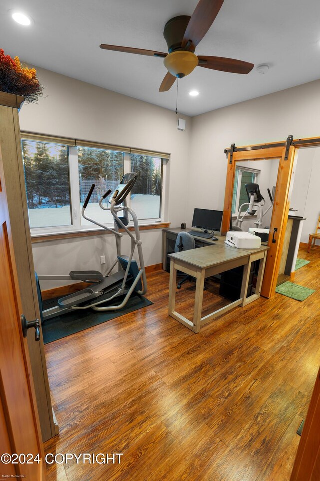 34184 House Dr, Soldotna, AK 99669 - office area featuring recessed lighting, a ceiling fan, plenty of natural light, wood finished floors, and a barn door