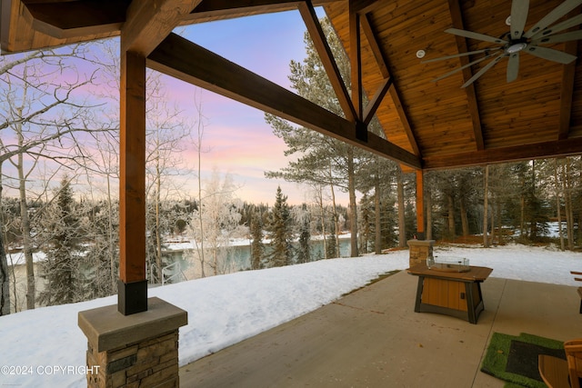 34184 House Dr, Soldotna, AK 99669 - snow covered patio with a ceiling fan, view of scattered trees, and a patio