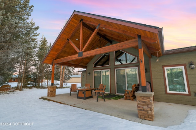 34184 House Dr, Soldotna, AK 99669 - back of property at dusk with a patio area and a fire pit