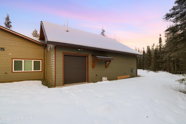 34184 House Dr, Soldotna, AK 99669 - view of snow covered exterior featuring a garage