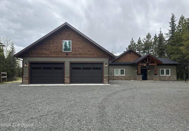 34184 House Dr, Soldotna, AK 99669 - craftsman-style house with a garage, stone siding, and driveway
