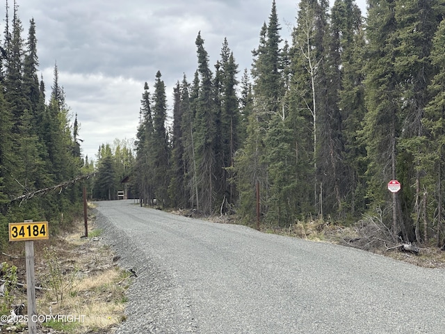 34184 House Dr, Soldotna, AK 99669 - view of asphalt road with a wooded view