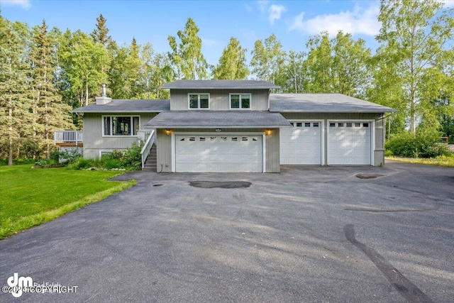 view of front of house with a garage and a front lawn