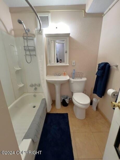 bathroom featuring shower / tub combination, tile patterned floors, and toilet