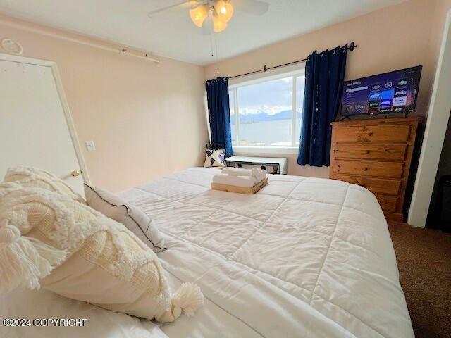 carpeted bedroom with ceiling fan