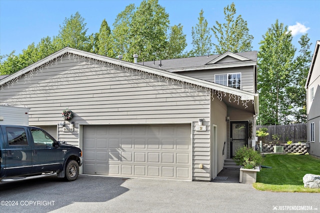 view of property exterior featuring a garage and a lawn