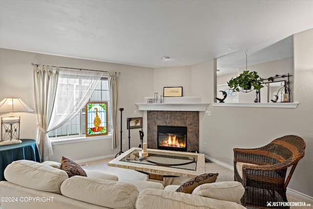 carpeted living room featuring a tile fireplace