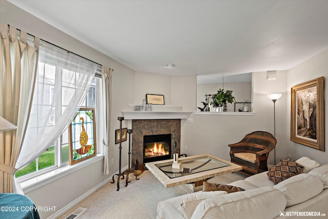 living room featuring carpet flooring and a tile fireplace