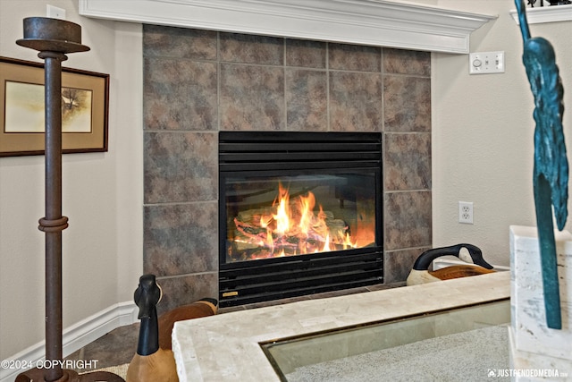 room details with ornamental molding and a tiled fireplace