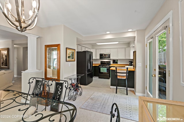 dining space with light carpet and decorative columns