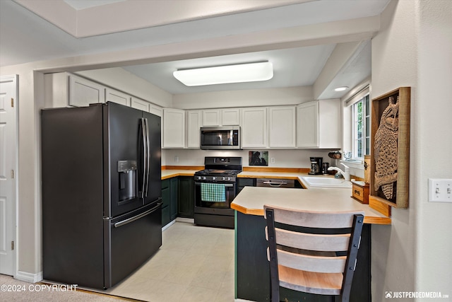 kitchen with white cabinets, stainless steel appliances, kitchen peninsula, and sink