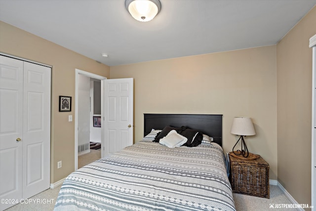 bedroom with a closet and light colored carpet