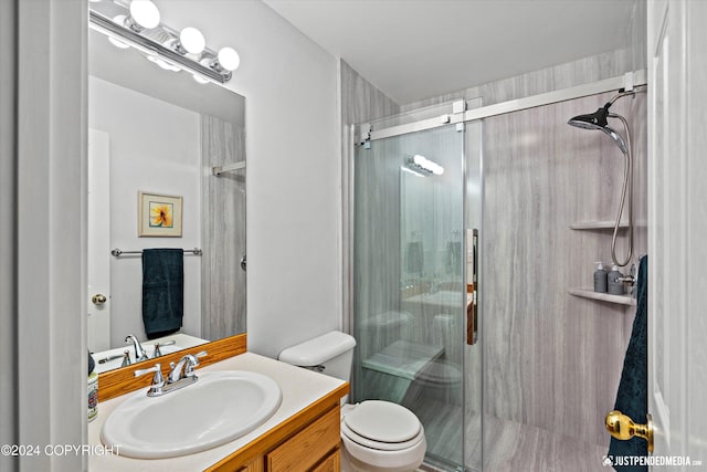 bathroom with vanity, an enclosed shower, and toilet