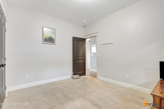 unfurnished bedroom with light carpet